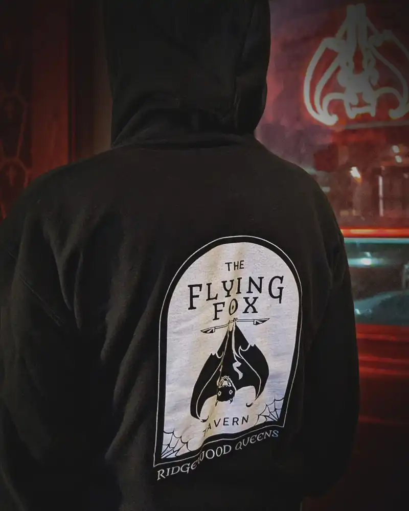 The back of a sweatshirt with prominent bat logo.
