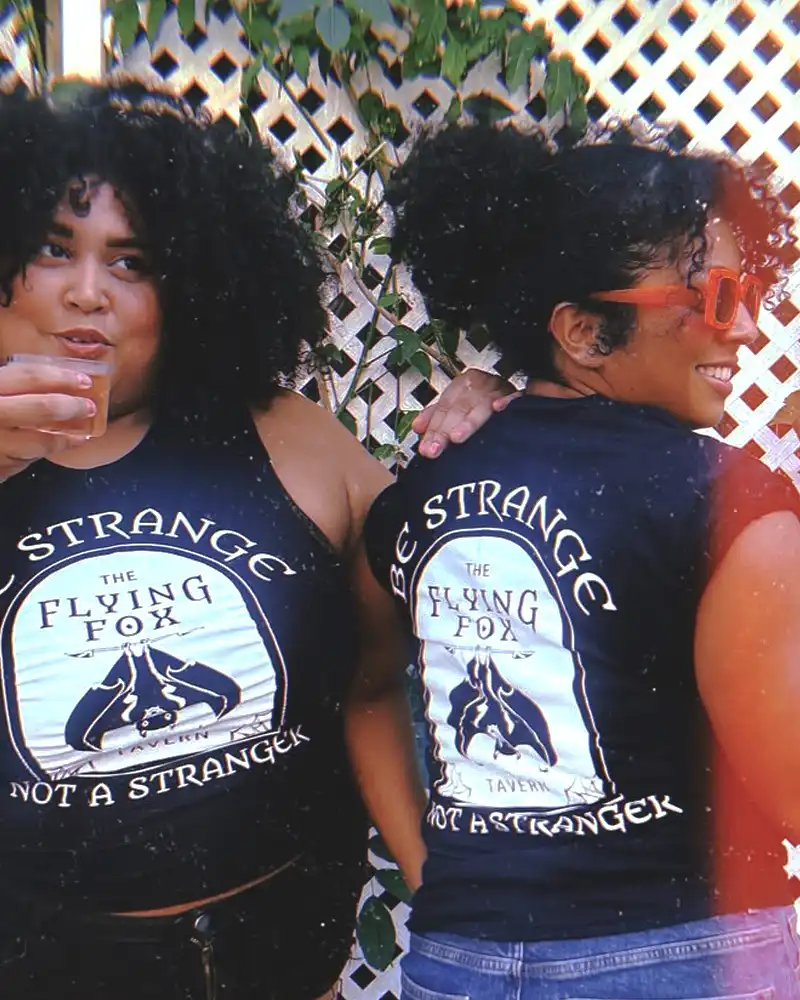 Two women wearing branded t-shirts.